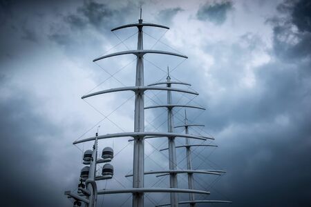 Masts of Sail modern Yacht against dramatic cloudy skyの写真素材