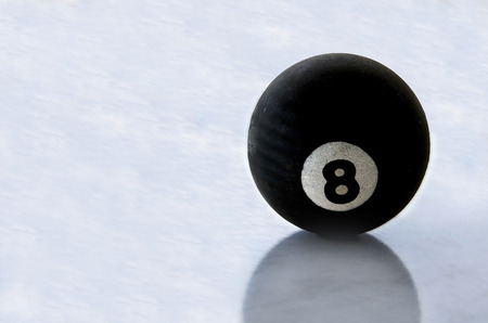 Pool black ball number eight on ice surface .の写真素材