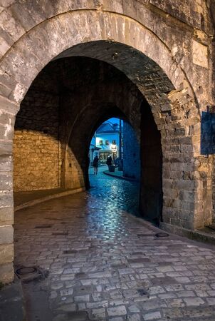 Arch entrance with stone walls to the old city of  Ioannina at night, Greeceの写真素材