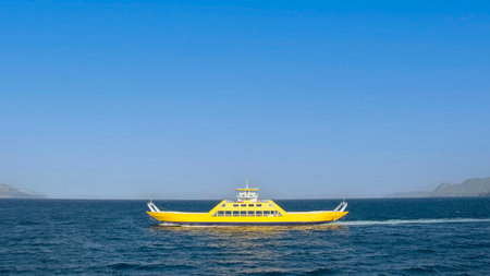 Flat yellow ferry boat on the Aegean sea, Evoia iasland. Greeceの写真素材