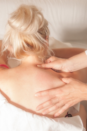 A physio gives myotherapy using trigger points on athlete womanの写真素材