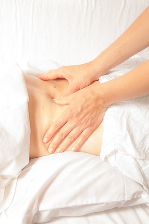 A physio gives myotherapy using trigger points on athlete woman