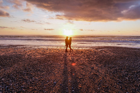 Couple in sunset beach, Greymouth NZ