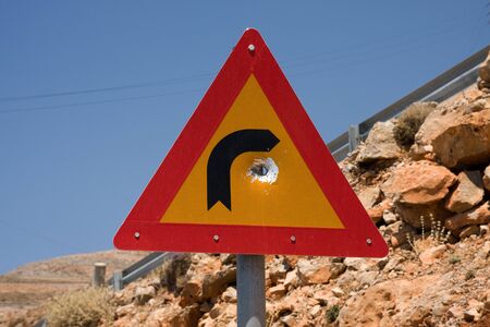 traffic sign with the hole made by the bulletの写真素材