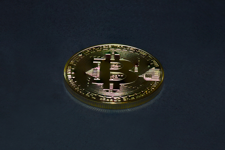 Gold coin bitcoin on a black backgroundの写真素材