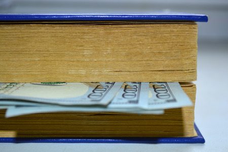 Book with a bookmark from dollars