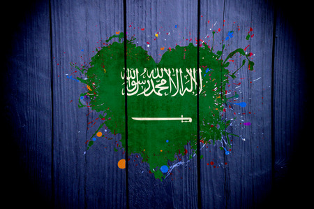 Flag of Saudi Arabia in the shape of a heart on a dark backgroundの写真素材