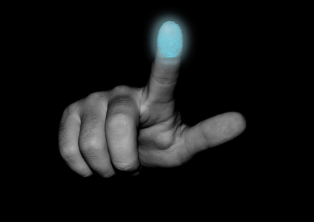The hand scans the fingerprint of the index fingerの写真素材
