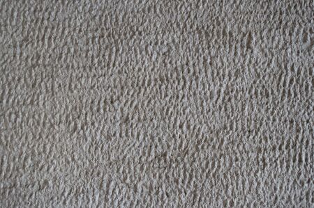 Rough textured stone surface with cracks, closeup