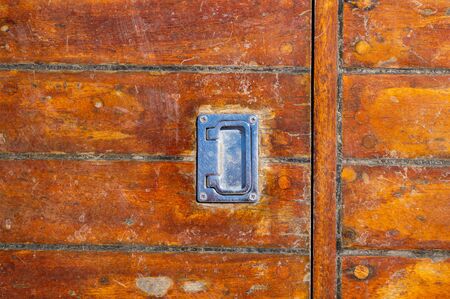 Wooden deck old shabby with a handle from the hatchの写真素材