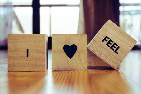 Wooden cubes with the words I LOVE TO FEEL in detailの写真素材