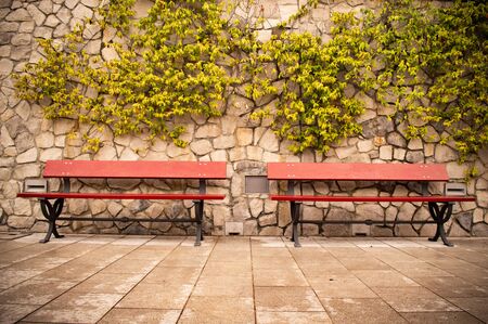 Two benches on a stone wall background close upの写真素材