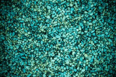 Background of sea pebbles in turquoise colors in detailの写真素材