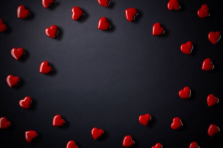 3D illustration of a lot of red hearts on a black backgroundの写真素材