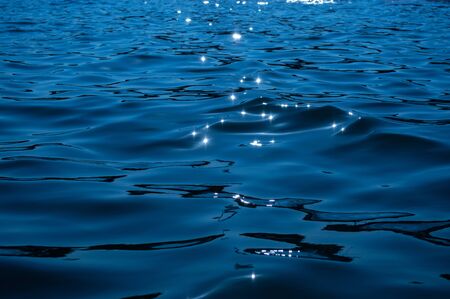 Gleams of sunshine on sea waves close upの写真素材