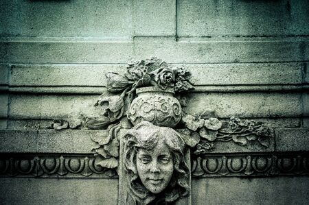 Antique textured stone bas-relief of a girl's face in detailの写真素材