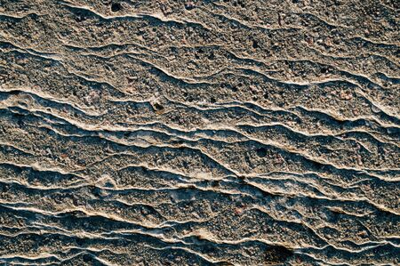 Concrete surface with relief and cracks in detailの写真素材