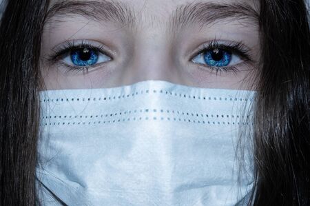 Teenager girl in a medical mask close up in detail