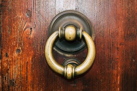 Old iron ring on the door for knocking close up