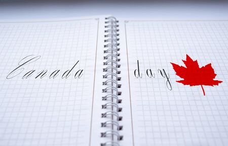 On a piece of paper is the inscription Canada Day and a maple leaf.の写真素材