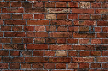 Old brickwork with scuffs and cracks close upの写真素材