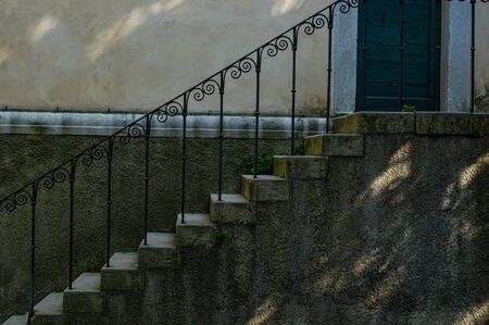 Old stone steps with wrought iron railings close upの写真素材
