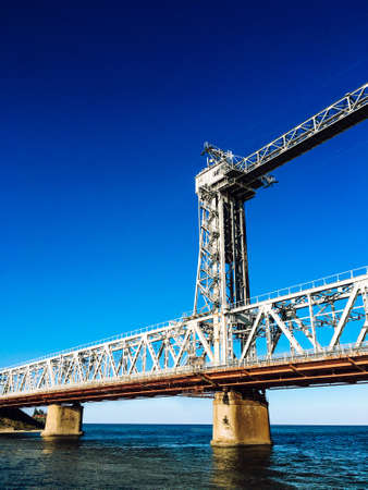 Iron bridge over the blue sea close up