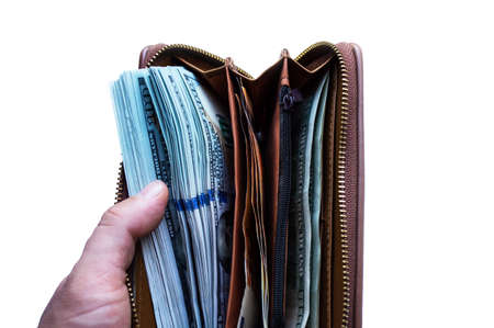 An open wallet with a lot of money close up