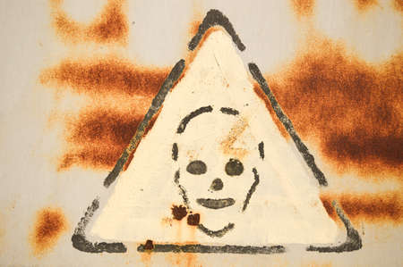 Danger sign on rusty surface close upの写真素材