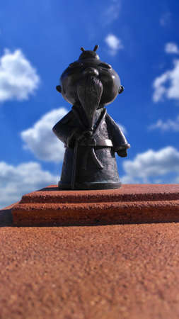 Bronze statuette of an old Asian on a white background close upの写真素材