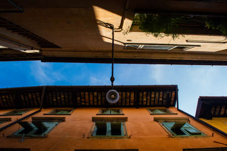 Narrow street of an Italian town with a perspective upwards close upの写真素材
