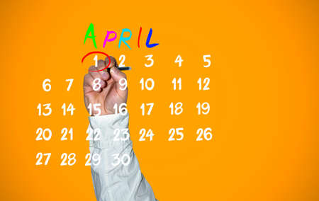 April fools day. Hand traces 1 number on the calendar close up.の写真素材