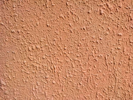 The porous texture of beige decorative plaster in detailの写真素材
