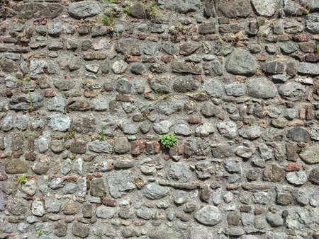 The old wall is made of stones in detail
