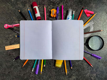 The first day at school. Close up School notebook with pencils, pens, ruler, compasses, magnifying...