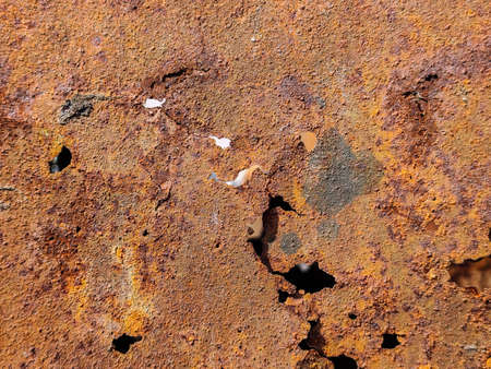 Texture of rusty metal with holes close up.