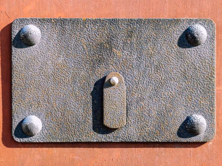 Old keyhole with rivets close up in detail.