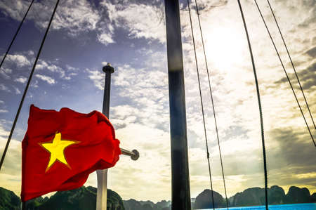 View on Vietnamese Flag on boat by Halong Bay - Vietnamの写真素材