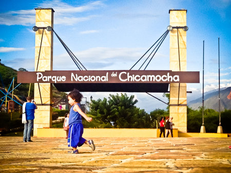 National park Chicamocha Canyon, Colombia on 29th October 2014: View on Children running in front of entrance gate of national parkのeditorial素材