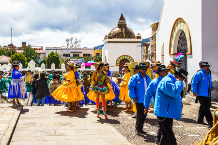 Cocacabana, Bolivia 30th April 2017: View on group of local people celebrating parade and playing drum and woman in dress dancingのeditorial素材