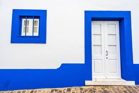 Traditional white houses with blue stripes, Portugalの写真素材
