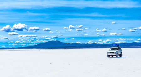 Off-road car in the Salar de Uyuni is largest salt flat in the World - Altiplano, Bolivia, South America. High quality photoの写真素材