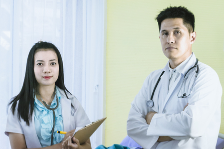 Male and female doctors stand in patient rooms. To diagnose illness Health Concepts and Treatmentの写真素材