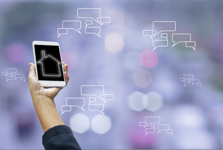Smartphones in hand women, on screen message symbols and wifi, blurred bokeh from car lights and traffic jams, with concept of wireless connectivity and communication and convenient communication to cover all areas for customers.の写真素材