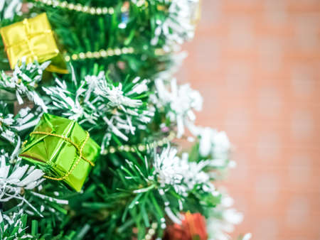 Red ball and gold star green tree pine use decoration on interior window shop store design for celebration happy new year 2021 holiday vacation winter season december merry christmasの写真素材
