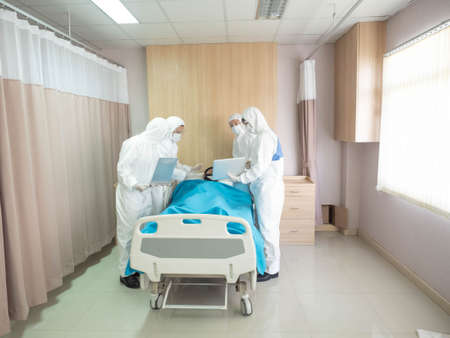 hospital clinic or laboratory doctor scientist wear ppe white isolated uniform Sick bed patient...