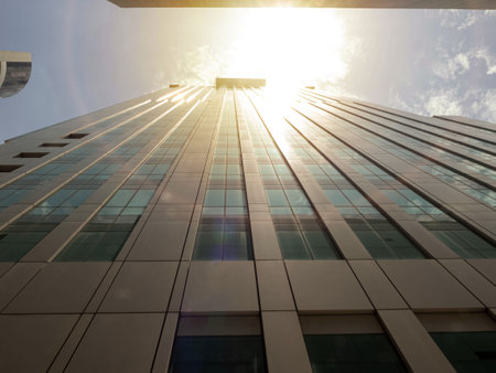 Building city architecture skycraper cityscape view business urban condominium apartment hotel office company modern tower sun set rise sky cloud background rooftop landmark aerialの写真素材