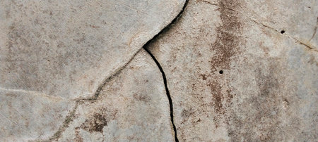 Weathered concrete walls show natural cracks and imperfections on their surface.