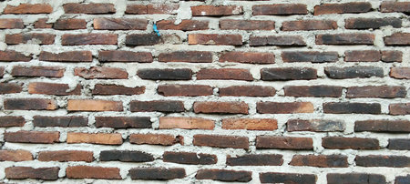 Rough brick wall texture with red, brown and light brown bricks with light mortar.の写真素材