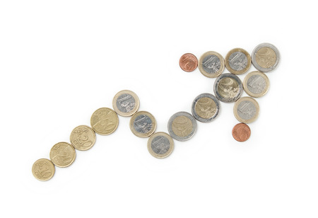Arrow symbol made out of euro coins isolated on a white backgroundの写真素材